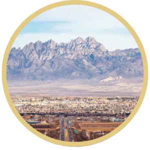 Photograph of Las Cruces, New Mexico with a gold, circular frame around it.